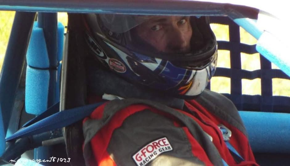 Robbie Mabe in his helmet and G-Force suit, strapped into the car